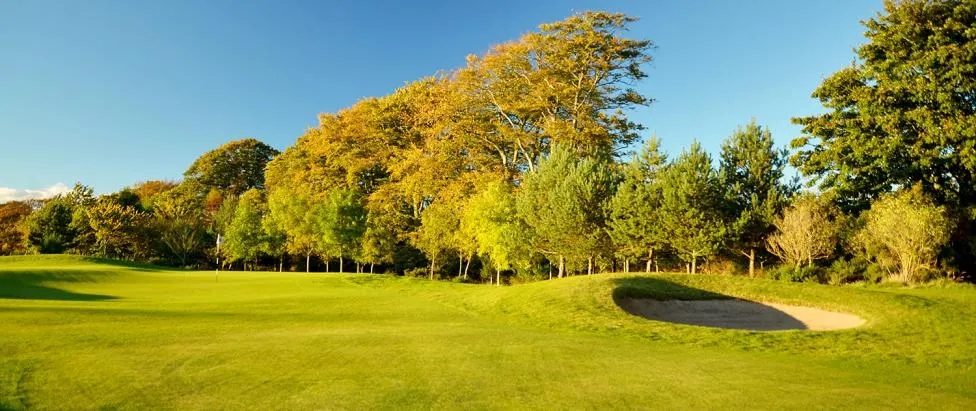 The 9th green and surrounding hills