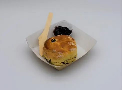 A homemade fruit scone with jam